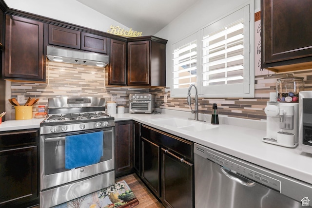 5171 W Dartford Way, West Valley City, UT 84120 - kitchen with sink, dark brown cabinets, stainless steel appliances, decorative backsplash, and light wood-type flooring
