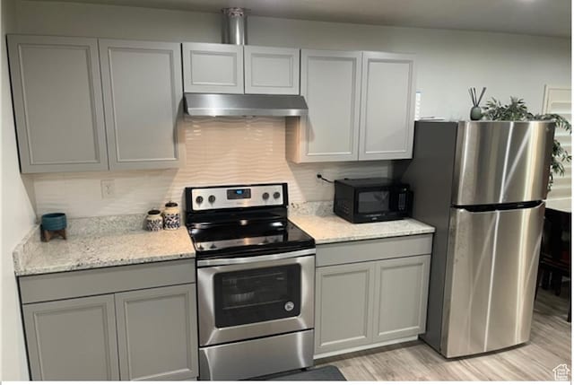 5171 W Dartford Way, West Valley City, UT 84120 - kitchen featuring appliances with stainless steel finishes, gray cabinetry, backsplash, light hardwood / wood-style floors, and light stone countertops