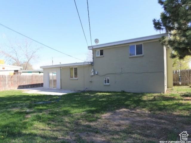 4548 W 4695 S, West Valley City, UT 84120 - rear view of property featuring a patio, a lawn, and fence