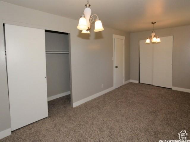4548 W 4695 S, West Valley City, UT 84120 - unfurnished bedroom with carpet, baseboards, and an inviting chandelier