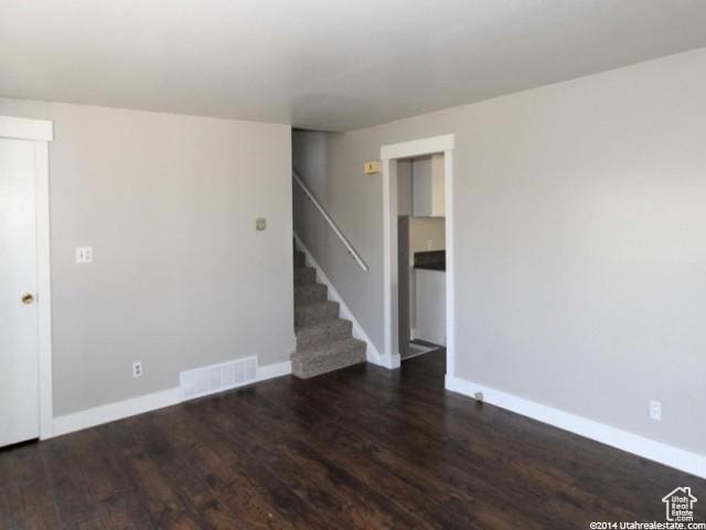 4548 W 4695 S, West Valley City, UT 84120 - unfurnished room featuring stairway, wood finished floors, visible vents, and baseboards