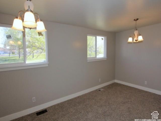 4548 W 4695 S, West Valley City, UT 84120 - interior space featuring baseboards, carpet, visible vents, and an inviting chandelier