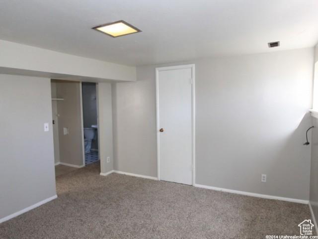 4548 W 4695 S, West Valley City, UT 84120 - unfurnished bedroom featuring carpet floors and baseboards