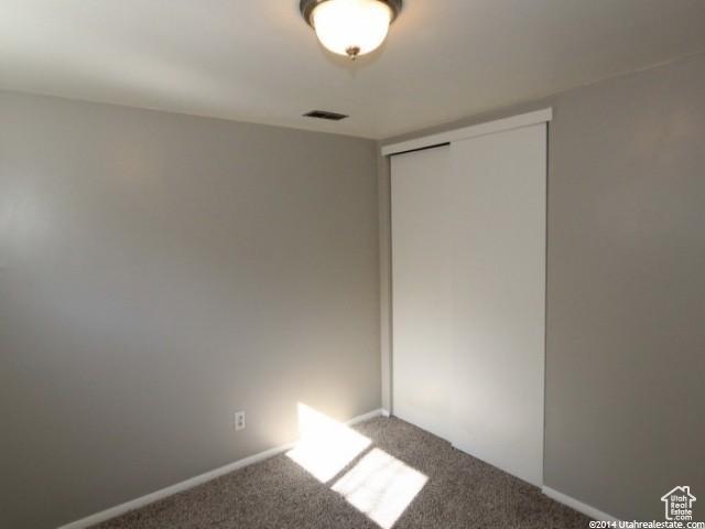 4548 W 4695 S, West Valley City, UT 84120 - unfurnished bedroom with carpet, a closet, visible vents, and baseboards