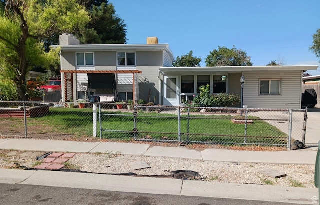 4548 W 4695 S, West Valley City, UT 84120 - view of front of property featuring a fenced front yard, a chimney, a gate, and a front lawn