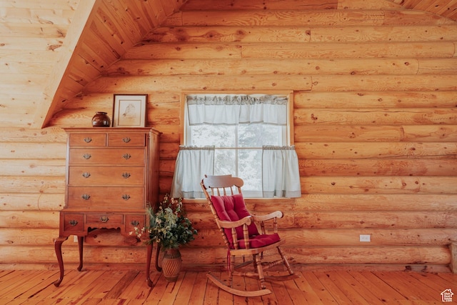 living area featuring log walls and light wood finished floors