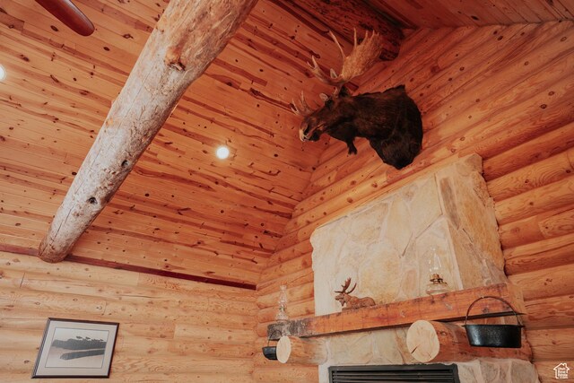 interior details with log walls, visible vents, beamed ceiling, and wooden ceiling
