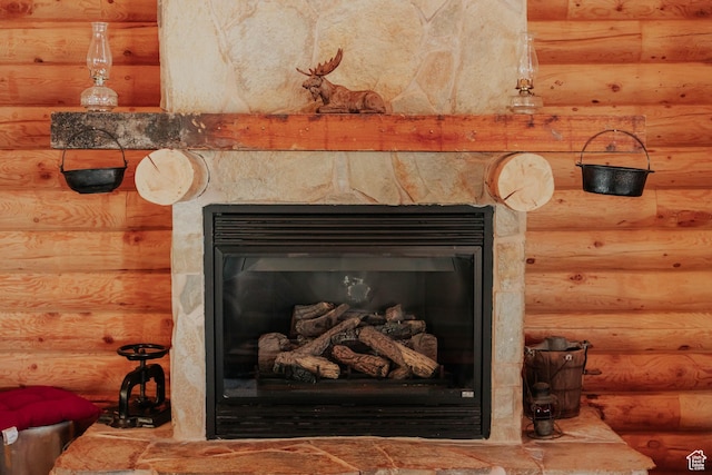 interior details featuring rustic walls and a fireplace