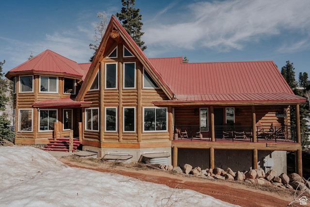 rear view of property featuring metal roof