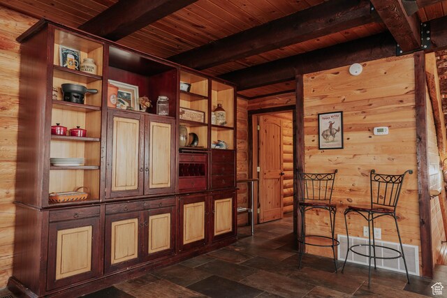 interior space featuring wood ceiling and beam ceiling