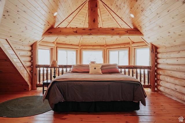 bedroom featuring multiple windows, rustic walls, light wood-style floors, and wood ceiling