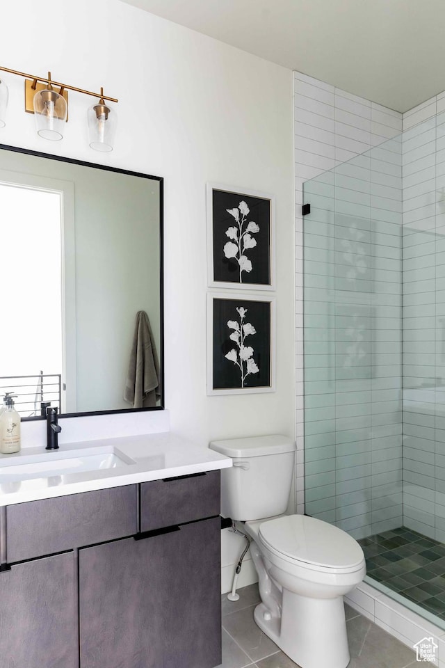 1318 Mahogany Way, Park City, UT 84098 - bathroom featuring tiled shower, vanity, toilet, and tile patterned flooring