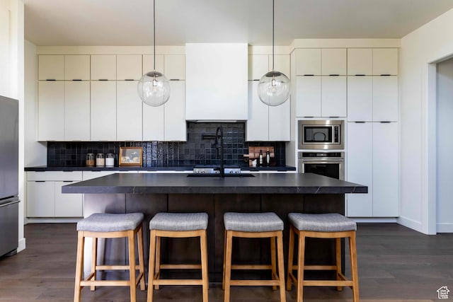 1318 Mahogany Way, Park City, UT 84098 - kitchen with a kitchen island with sink, dark wood-type flooring, stainless steel appliances, and white cabinets