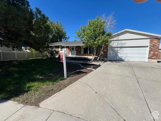 7548 S 3270 W, West Jordan, UT 84084 - ranch-style house with concrete driveway, an attached garage, and brick siding