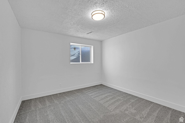 empty room featuring carpet floors and a textured ceiling