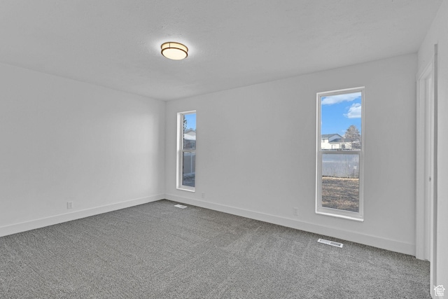 unfurnished room featuring carpet flooring