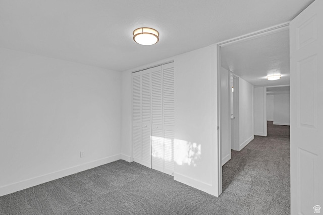 empty room with carpet and a textured ceiling