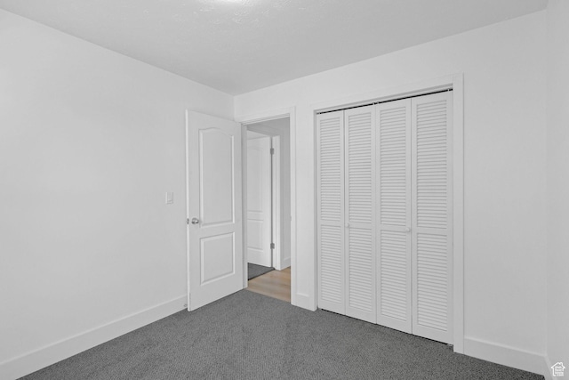 unfurnished bedroom featuring carpet floors and a closet