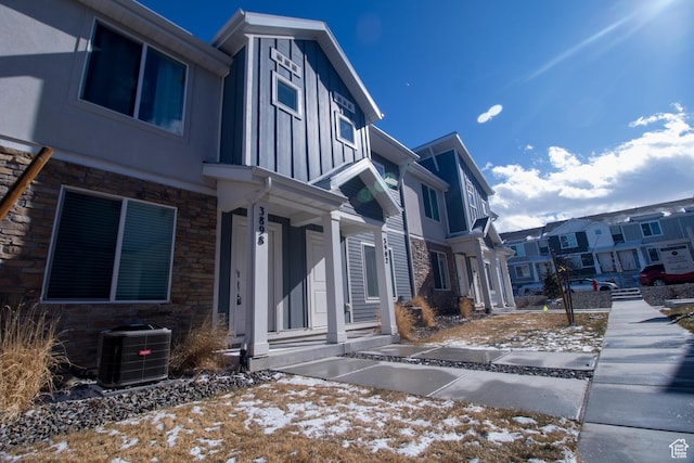 snow covered property featuring central AC unit