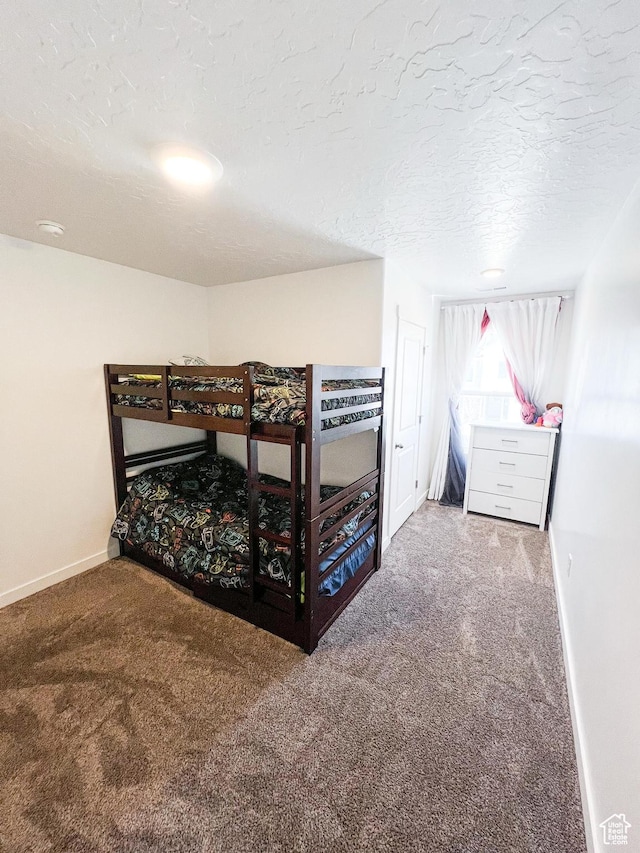 carpeted bedroom featuring a textured ceiling