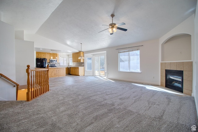1247 S Alpine Dr, Saratoga Springs, UT 84045 - unfurnished living room with lofted ceiling, light colored carpet, ceiling fan, a fireplace, and baseboards