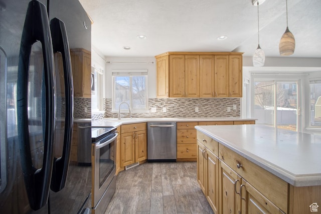 1247 S Alpine Dr, Saratoga Springs, UT 84045 - kitchen with stainless steel appliances, light wood-style flooring, tasteful backsplash, light countertops, and pendant lighting