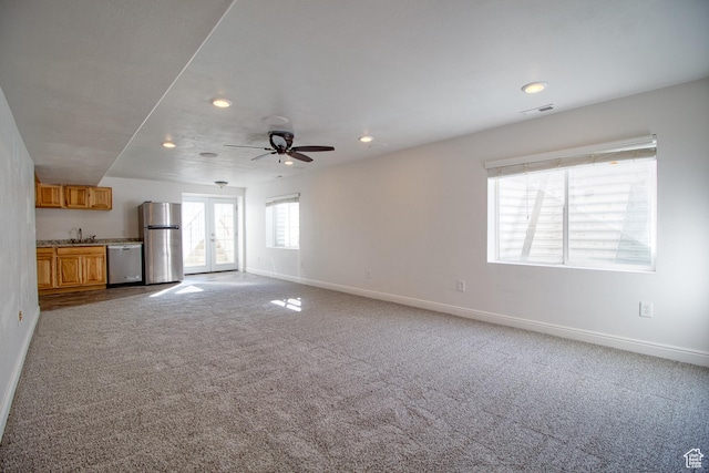1247 S Alpine Dr, Saratoga Springs, UT 84045 - unfurnished living room with baseboards, recessed lighting, carpet flooring, french doors, and a sink