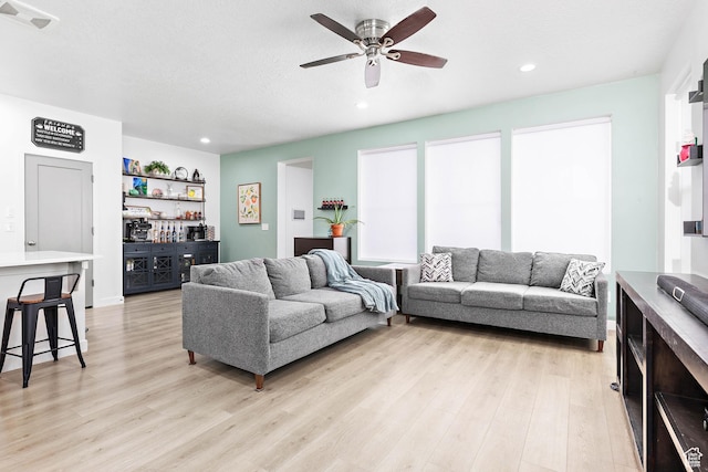 11283 S Willow Walk Dr W, South Jordan, UT 84009 - living area with light wood-style floors, recessed lighting, a ceiling fan, and a dry bar