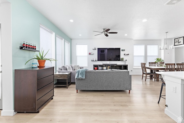 11283 S Willow Walk Dr W, South Jordan, UT 84009 - living area with ceiling fan, light wood-type flooring, recessed lighting, a textured ceiling, and a chandelier