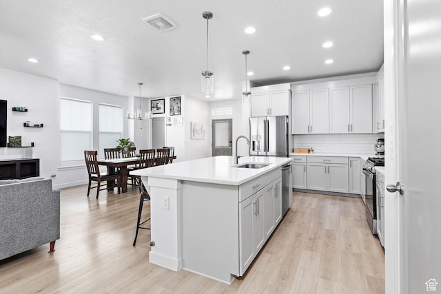 11283 S Willow Walk Dr W, South Jordan, UT 84009 - kitchen with appliances with stainless steel finishes, a sink, recessed lighting, light countertops, and tasteful backsplash