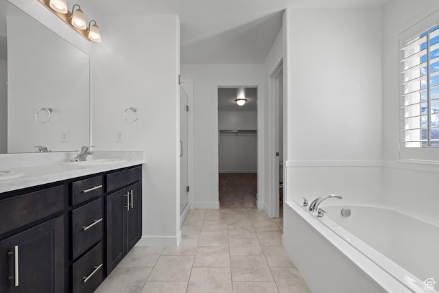 621 W 950 S, Springville, UT 84663 - bathroom with tile patterned floors, a garden tub, a sink, double vanity, and a spacious closet