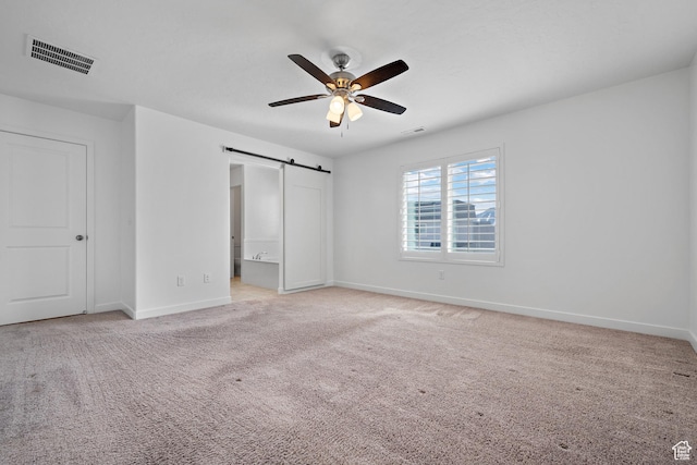 621 W 950 S, Springville, UT 84663 - unfurnished bedroom with a barn door, visible vents, and light carpet