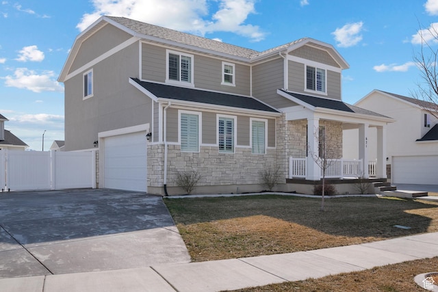 621 W 950 S, Springville, UT 84663 - view of front of house featuring stone siding, covered porch, driveway, and fence