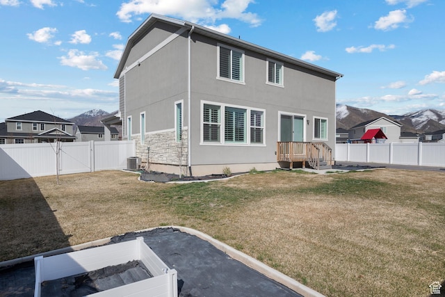 621 W 950 S, Springville, UT 84663 - back of property with a lawn, cooling unit, a fenced backyard, stone siding, and a gate