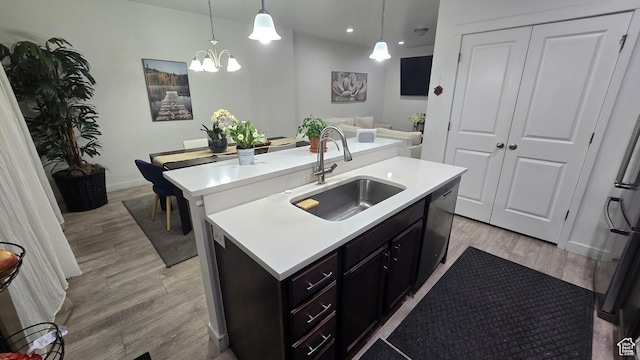 5343 W Big Sur Dr, South Jordan, UT 84009 - kitchen featuring an island with sink, hanging light fixtures, light countertops, light wood-type flooring, and a sink