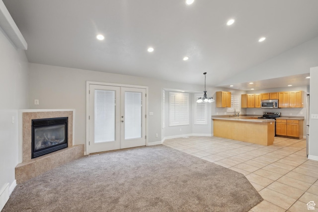 877 S 200 W, Mona, UT 84645 - kitchen with pendant lighting, light brown cabinetry, light colored carpet, kitchen peninsula, and stainless steel appliances