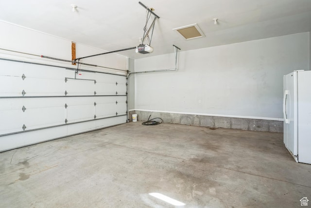 877 S 200 W, Mona, UT 84645 - garage featuring a garage door opener and white fridge