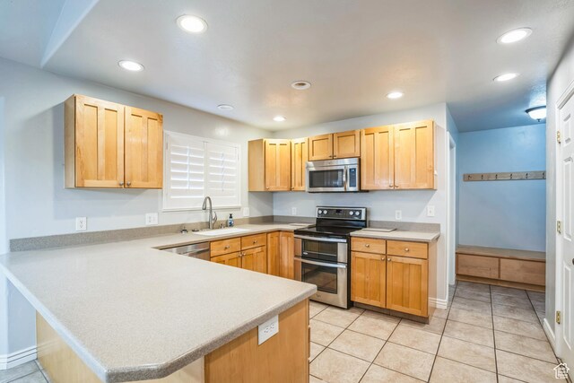 877 S 200 W, Mona, UT 84645 - kitchen featuring appliances with stainless steel finishes, light brown cabinetry, sink, light tile patterned floors, and kitchen peninsula