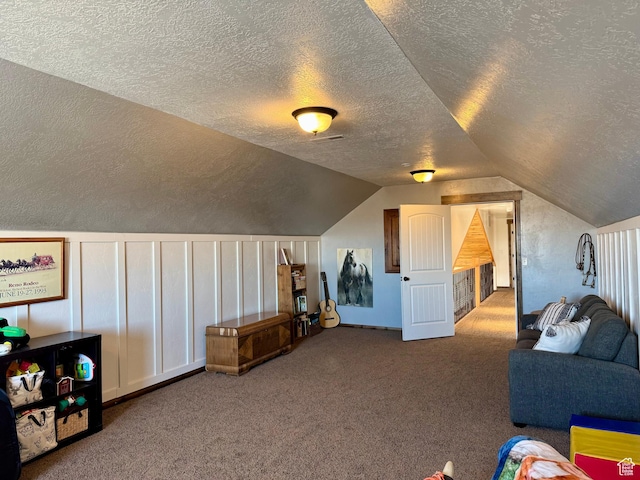additional living space featuring vaulted ceiling, carpet floors, and a textured ceiling