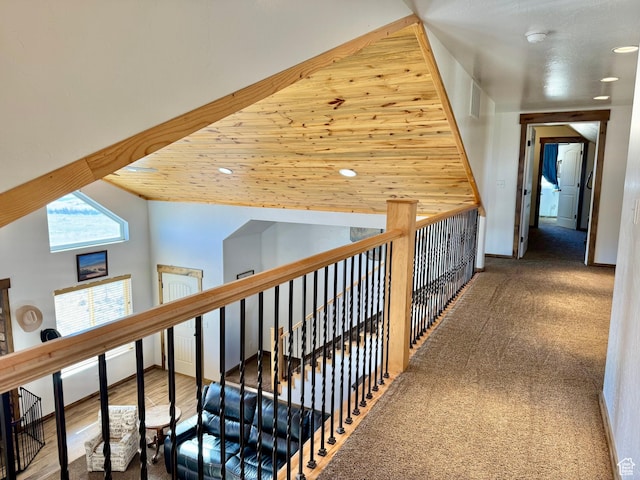hall featuring lofted ceiling, recessed lighting, and an upstairs landing