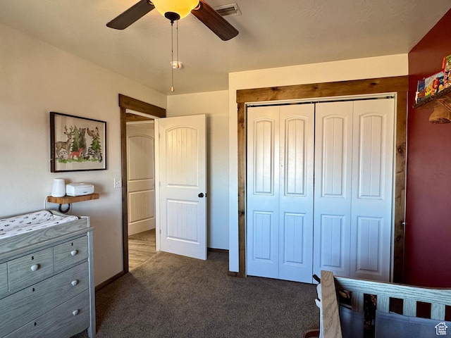bedroom featuring a ceiling fan, dark colored carpet, visible vents, and a closet