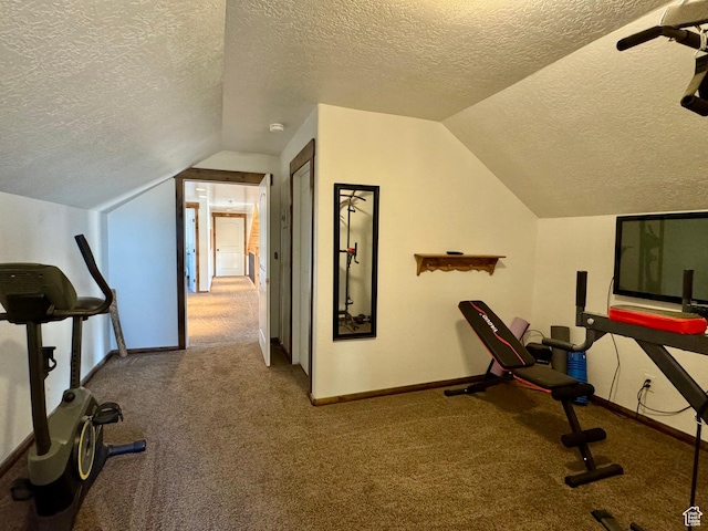 exercise area featuring vaulted ceiling, a textured ceiling, baseboards, and carpet