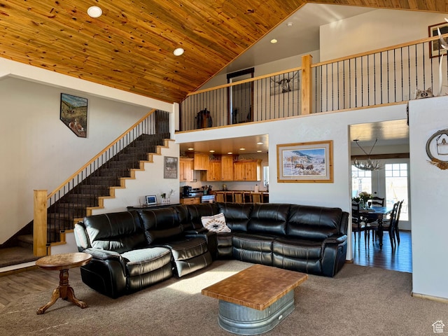 living room featuring high vaulted ceiling, carpet floors, stairs, and recessed lighting