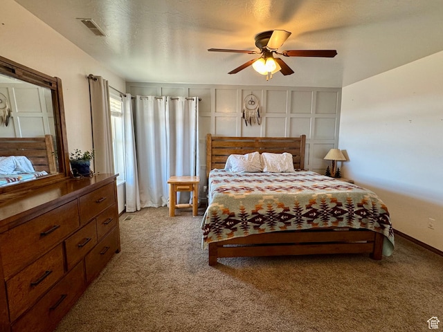 bedroom with visible vents, a ceiling fan, baseboards, and light carpet