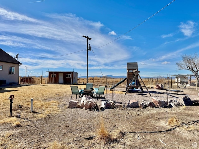 view of yard with an outbuilding and a playground