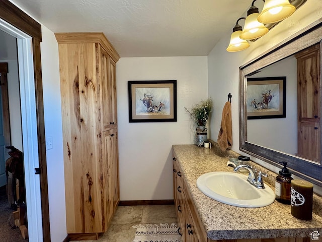 bathroom featuring baseboards and vanity