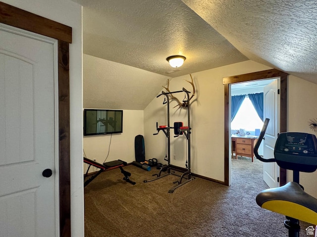 exercise room featuring lofted ceiling, baseboards, a textured ceiling, and carpet flooring