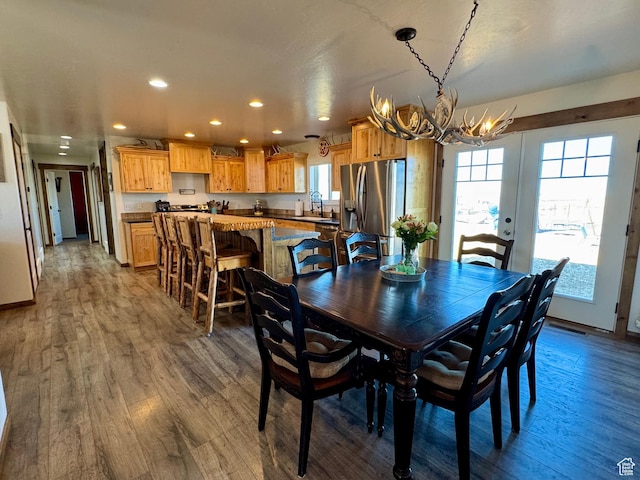 dining room with baseboards, recessed lighting, a notable chandelier, and dark wood finished floors