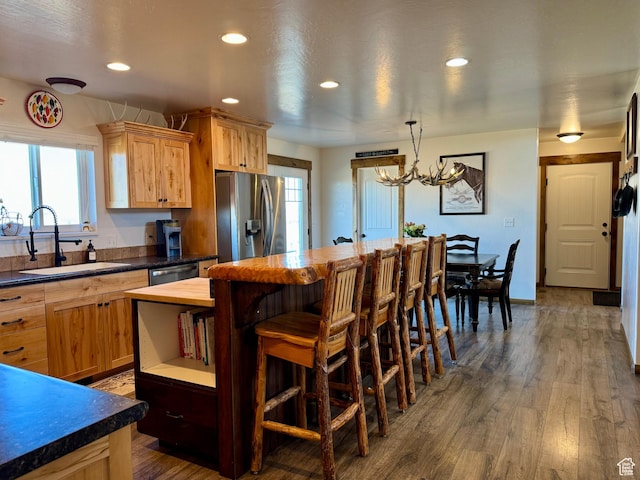 kitchen with stainless steel appliances, a sink, recessed lighting, and a healthy amount of sunlight