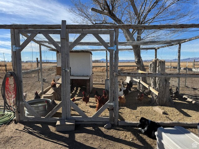 view of yard with an outdoor structure, a mountain view, and exterior structure